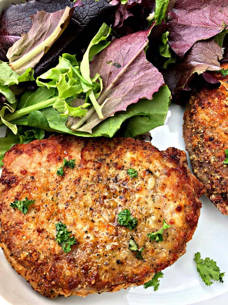 air fryer pork chops in a white bowl with salad