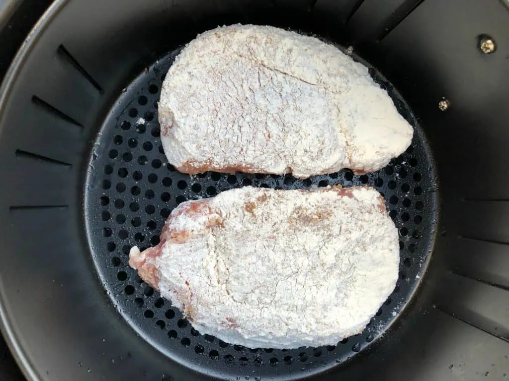 raw pork chops with flour in an air fryer
