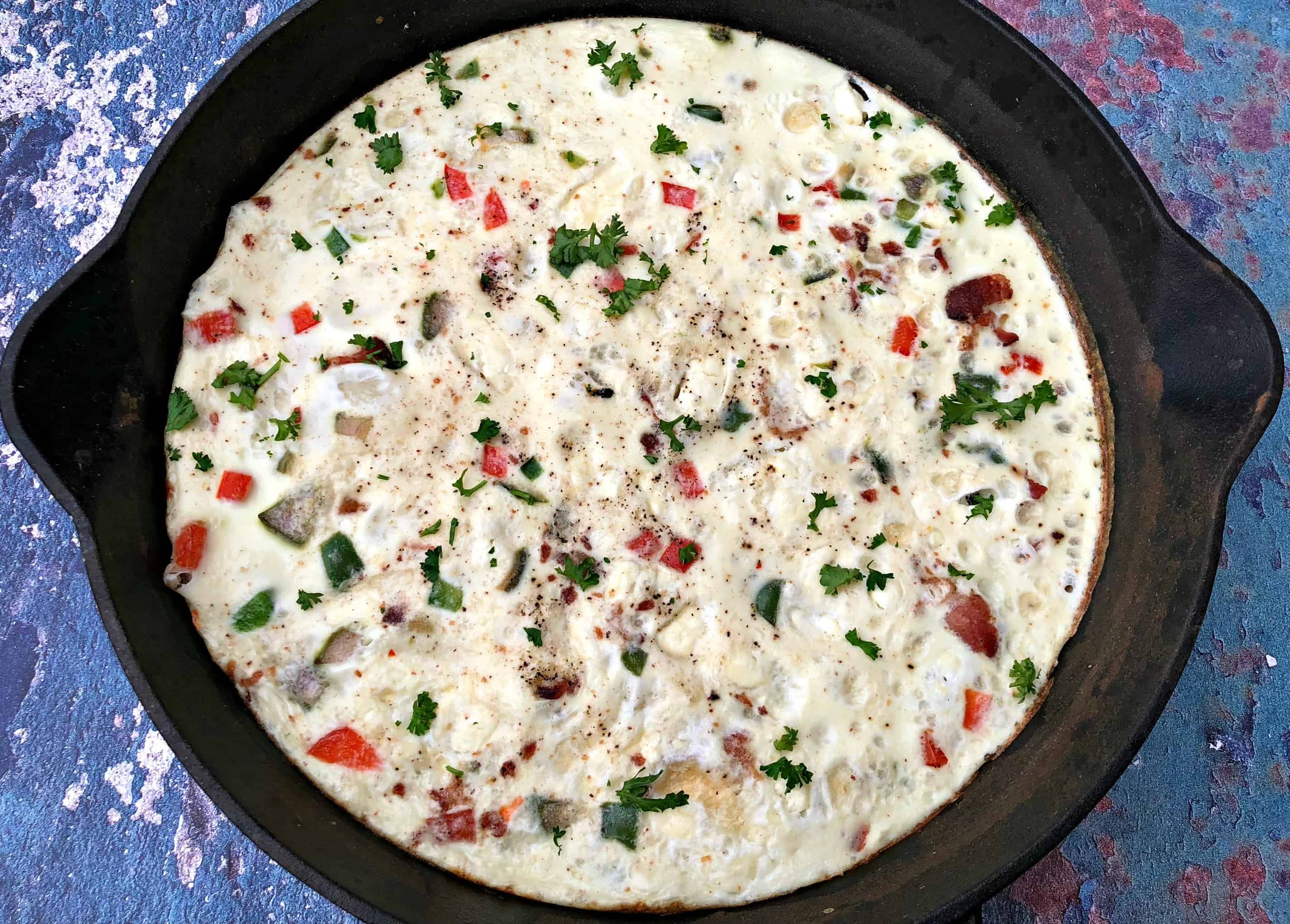 Post-Workout Egg White and Bacon Frittata Protein Recipe in a black cast iron skillet