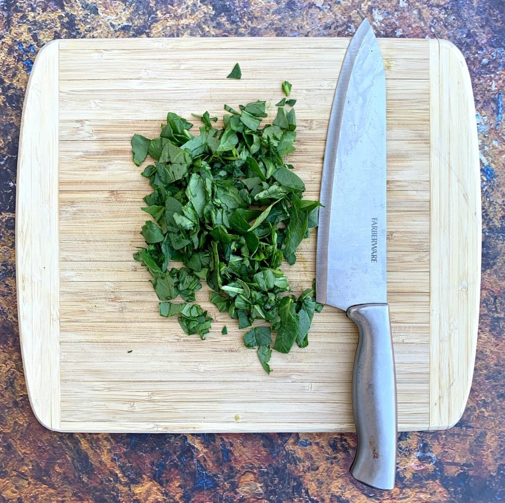 sliced spinach on a cutting board