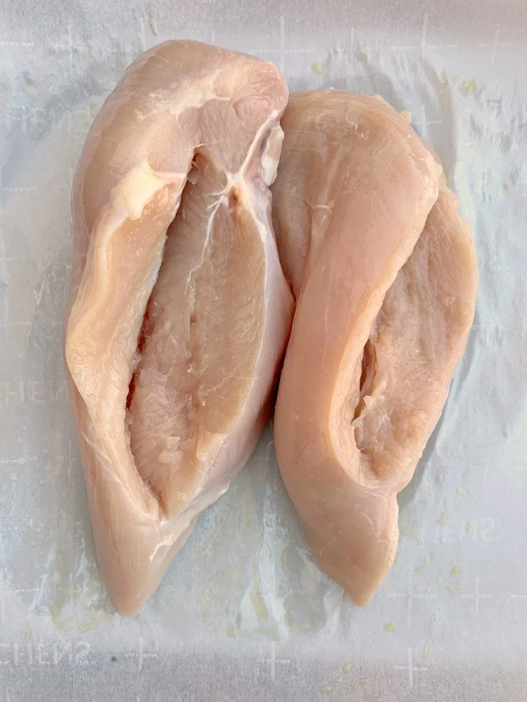 raw chicken breasts sliced with side pockets