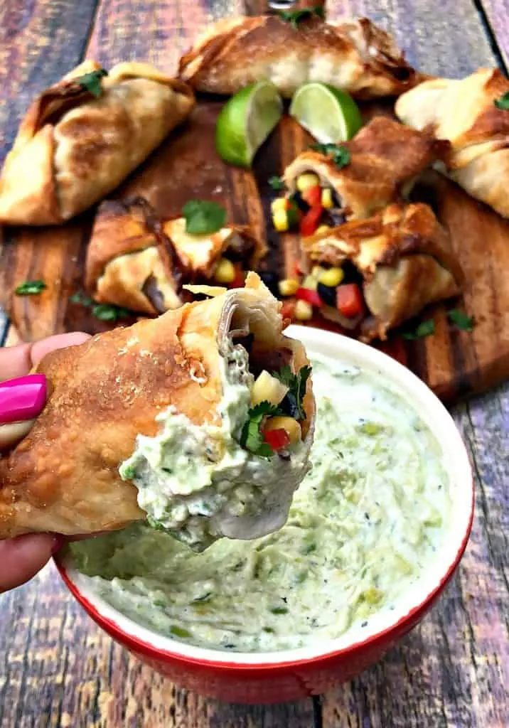 air fryer southwestern egg roll cut in half with avocado ranch dip