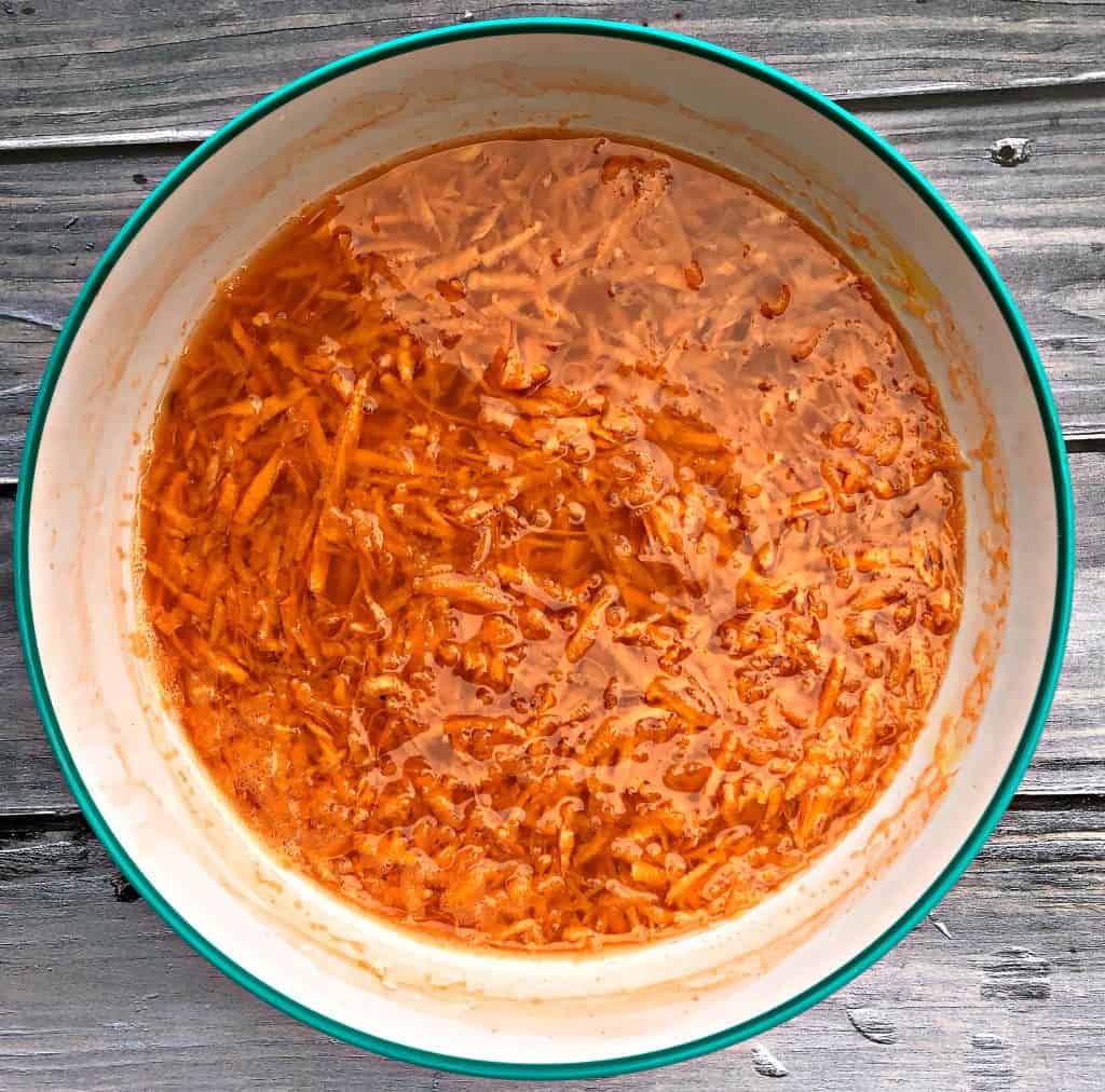 grated sweet potatoes in cold water