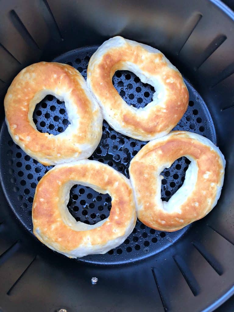 biscuit donut cut outs placed in an air fryer