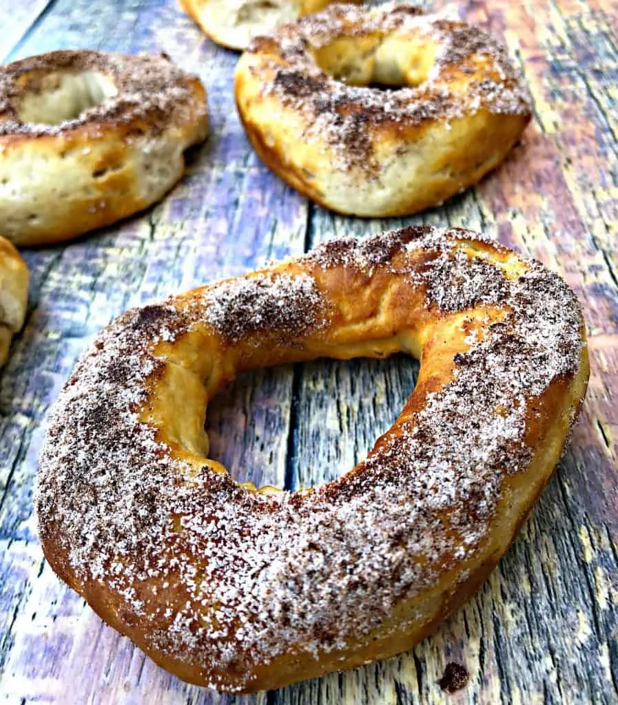 Air Fryer Cinnamon Sugar Donuts on a multi colored surface