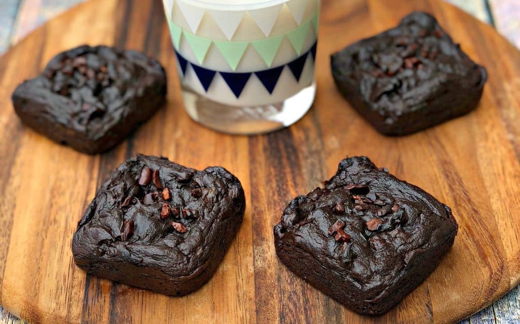 avocado brownies with milk on a brown cutting board