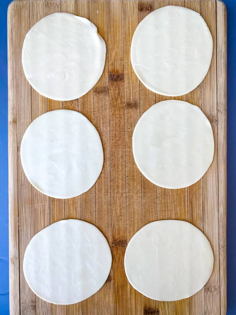 empanada wrappers on a cutting board