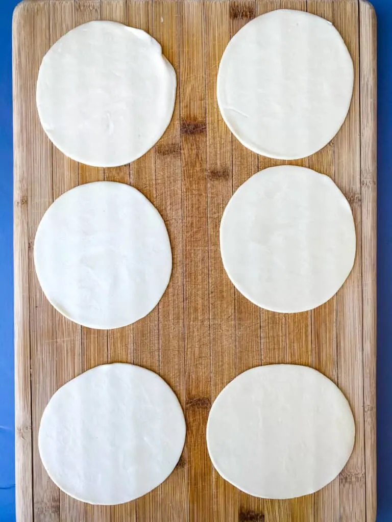 empanada wrappers on a cutting board