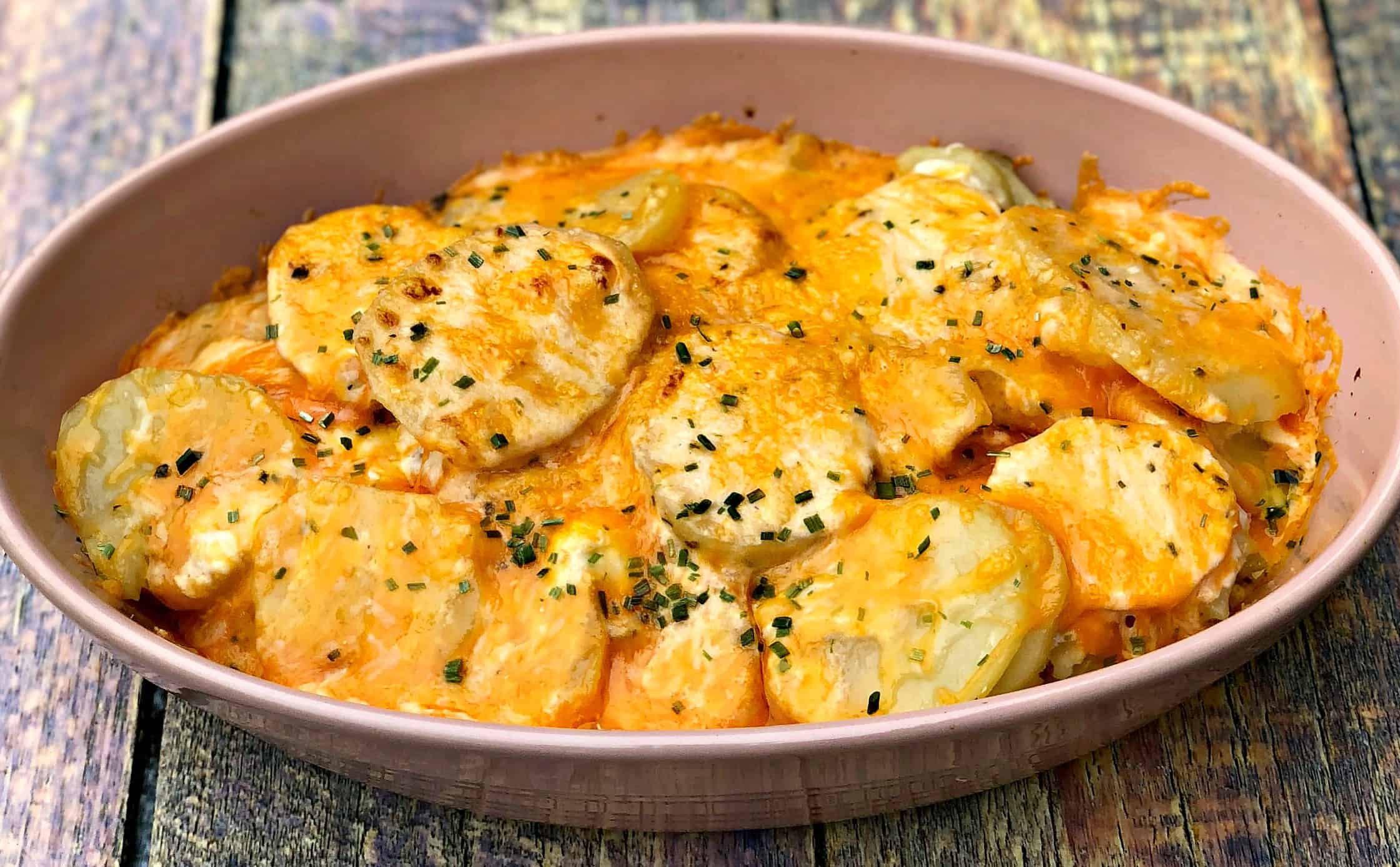 instant pot scalloped potatoes in a pink bowl