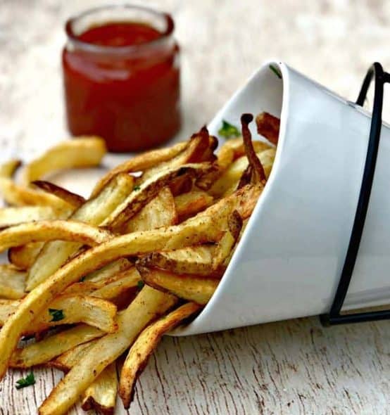 air fryer fries air fryer fries spread out on a brown surface with ketchup