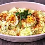 instant pot potato salad with boiled eggs in a pink bowl