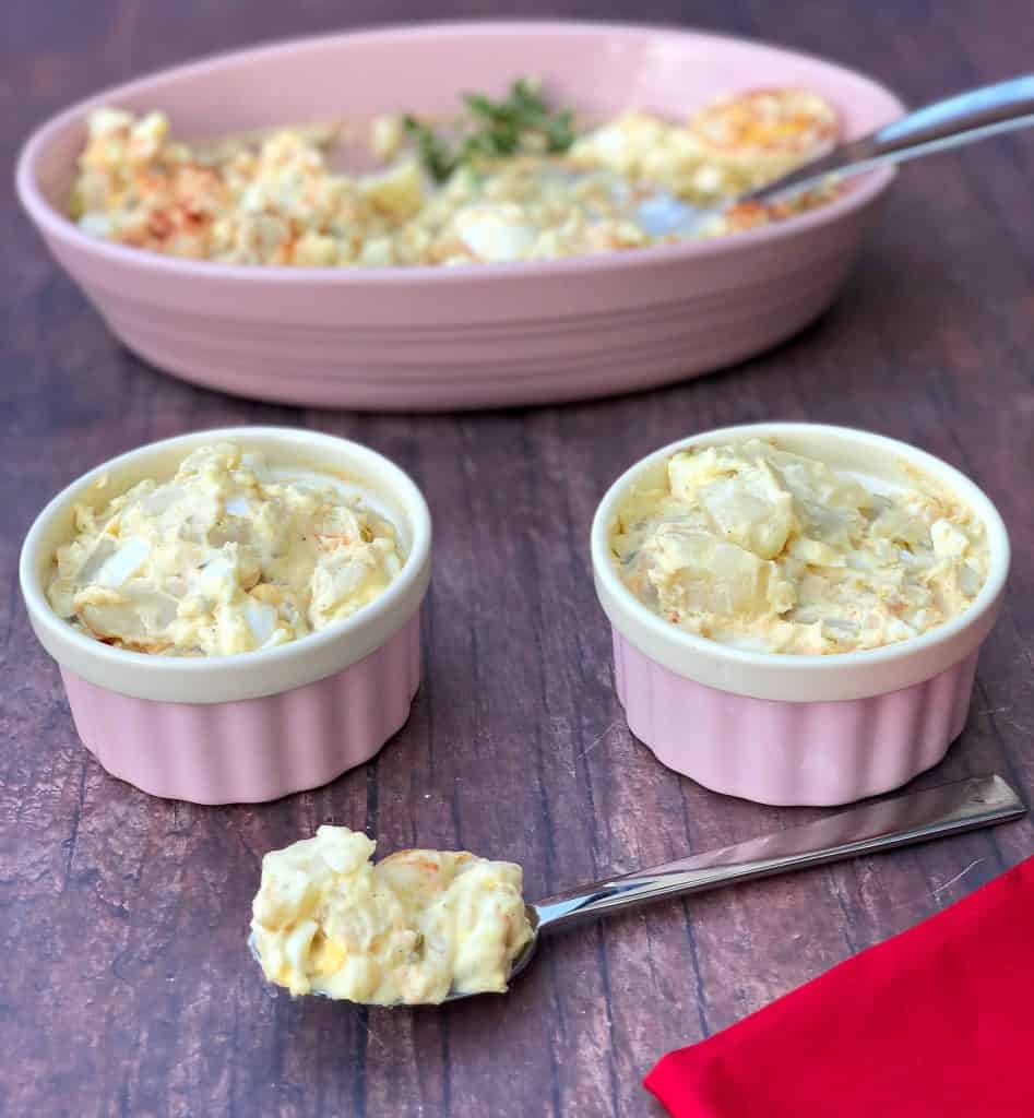 instant pot potato salad with boiled eggs in a pink bowl