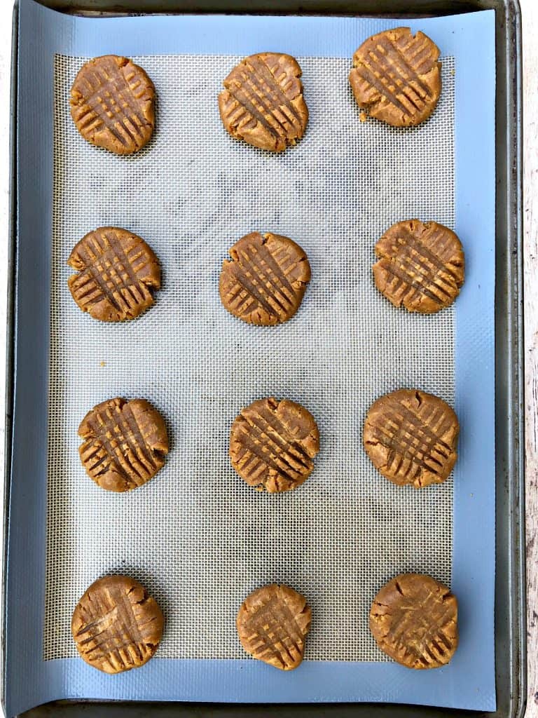 raw cookie dough balls on a cookie sheet