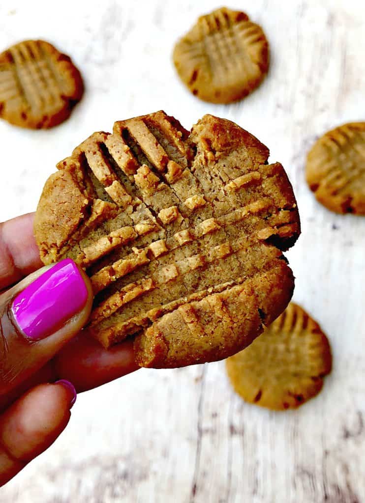 person holding keto peanut butter cookies