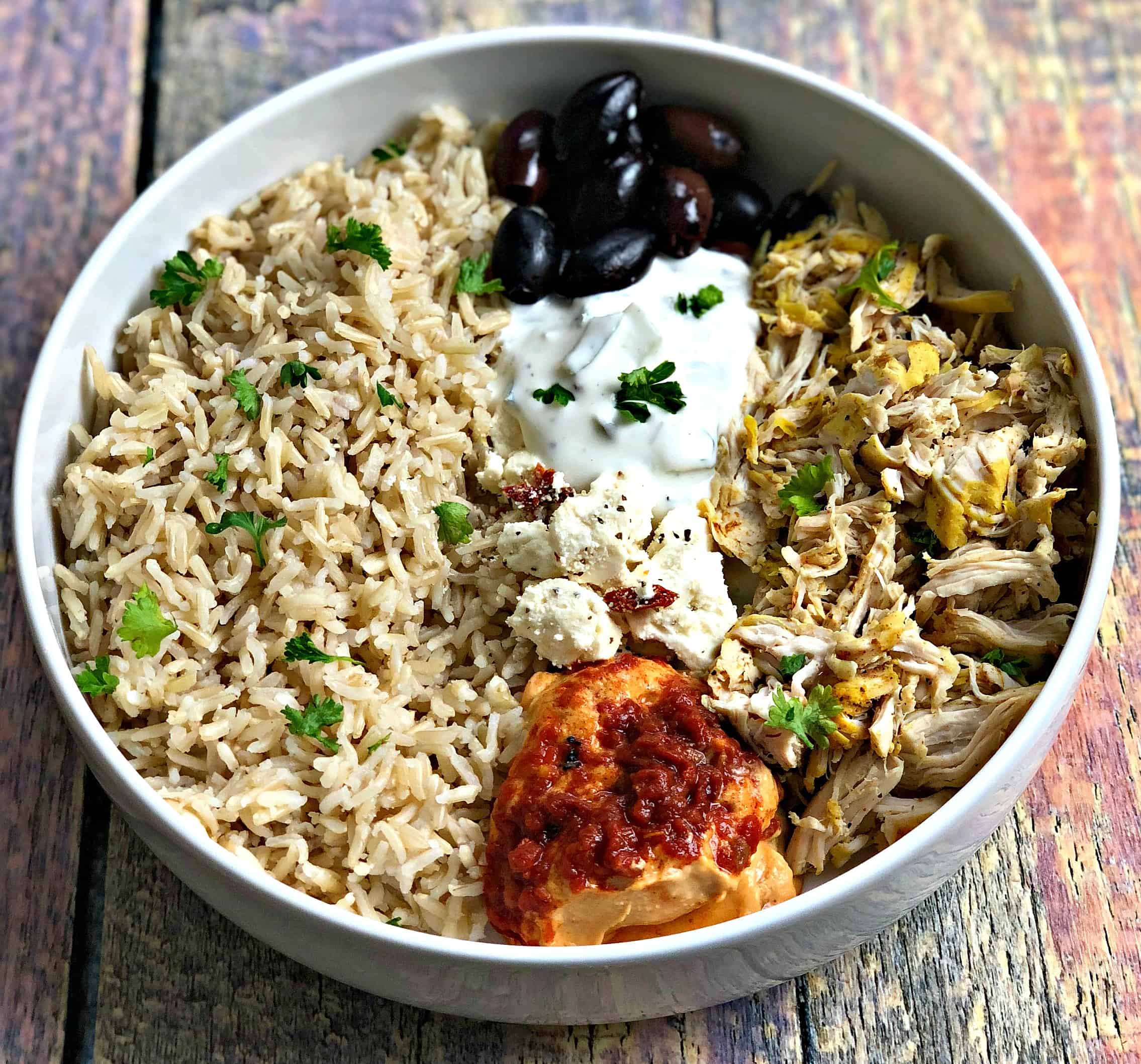 mediterranean chicken bowl in a white bowl