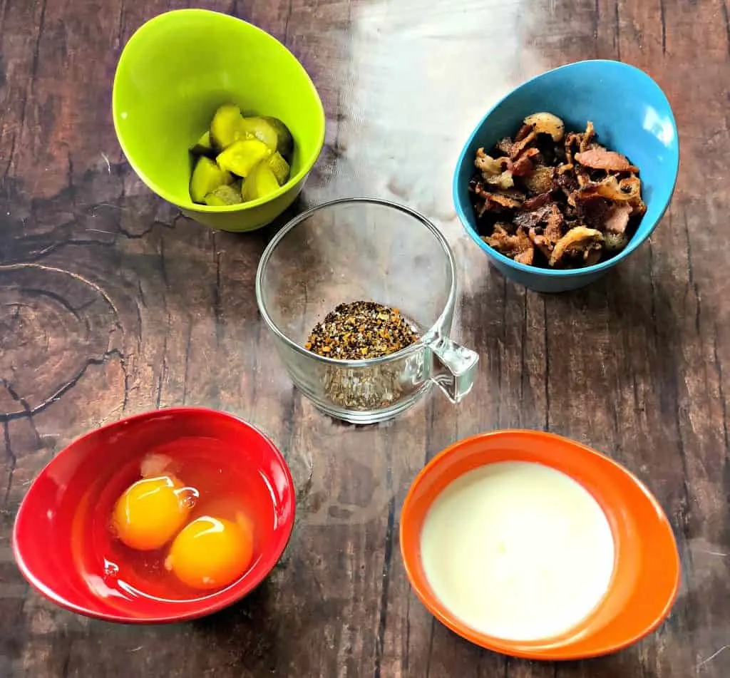 eggs, pickles, bacon, and heavy cream in small bowls.