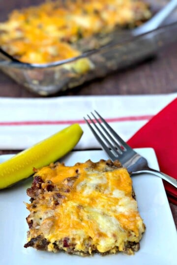 keto cheeseburger casserole with pickle on a white plate