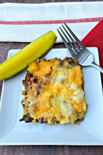 keto cheeseburger casserole with pickle on a white plate