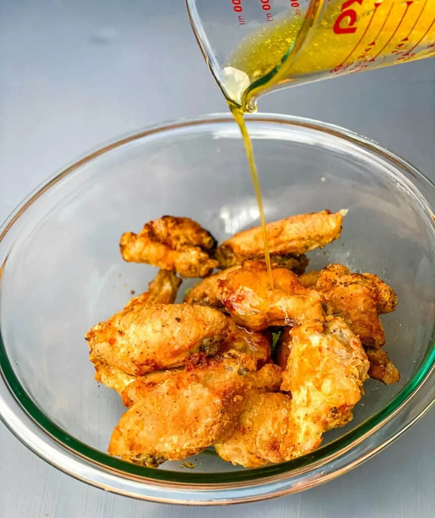 garlic butter parmesan sauce drizzled over chicken wings