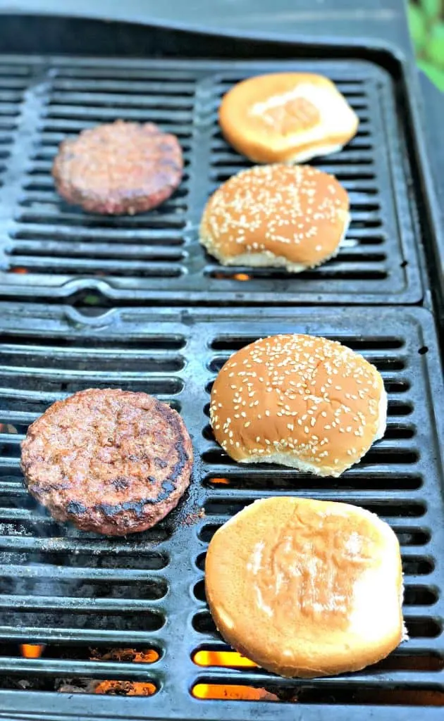 burgers cooking on a grill