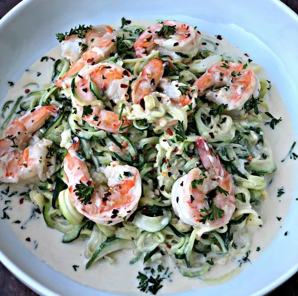 low carb zucchini alfredo in cream sauce on a white plate