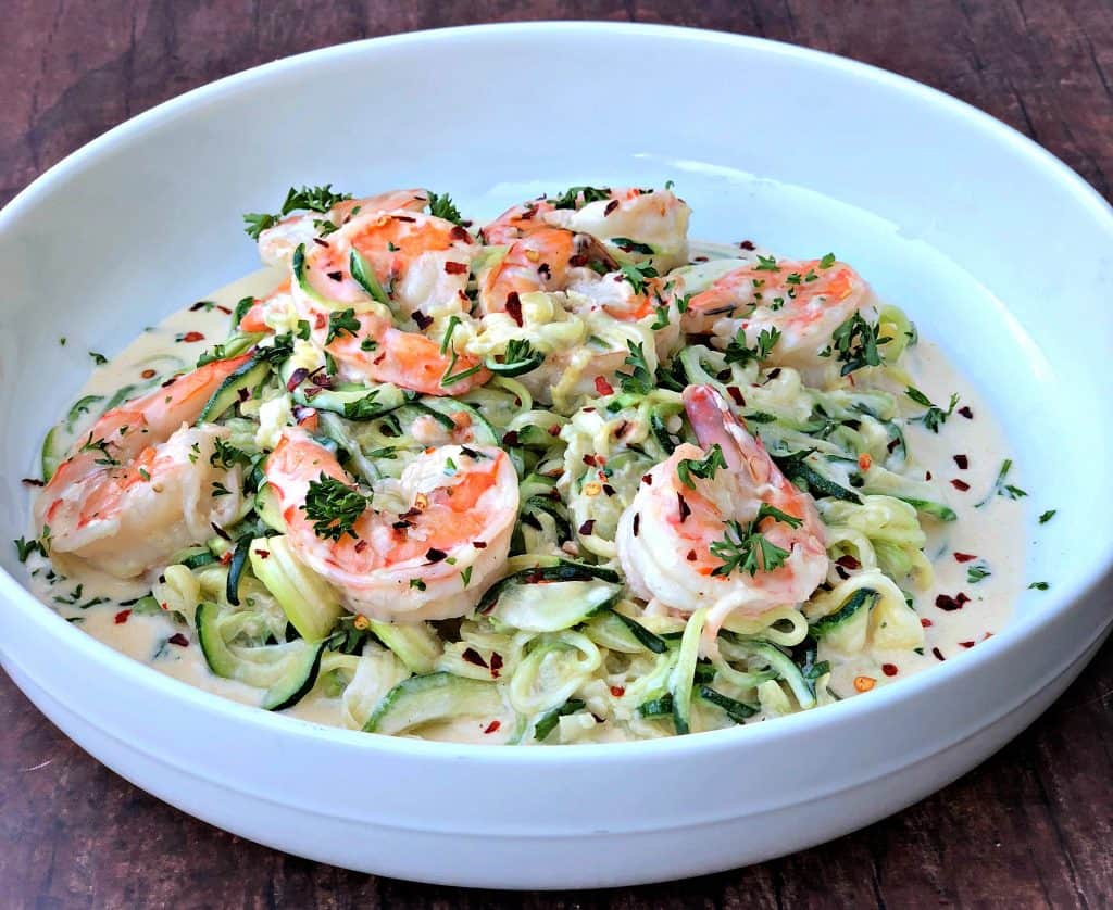 low carb zucchini alfredo in cream sauce on a white plate