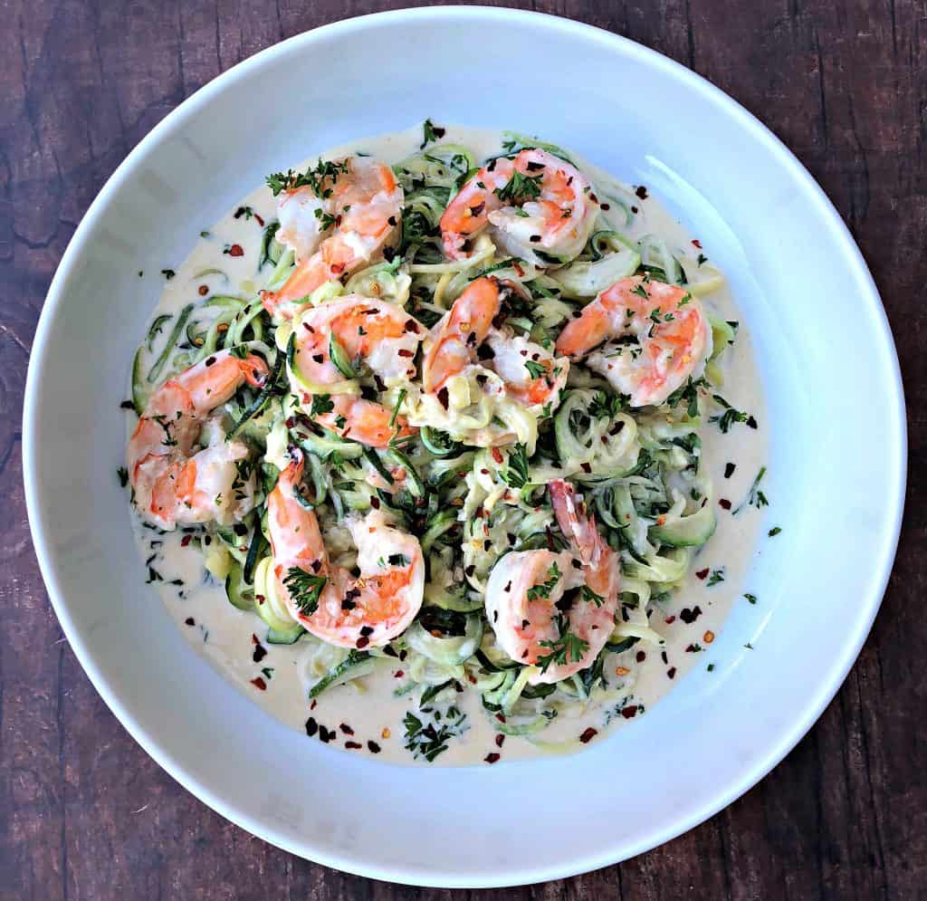 low carb zucchini alfredo in cream sauce on a white plate