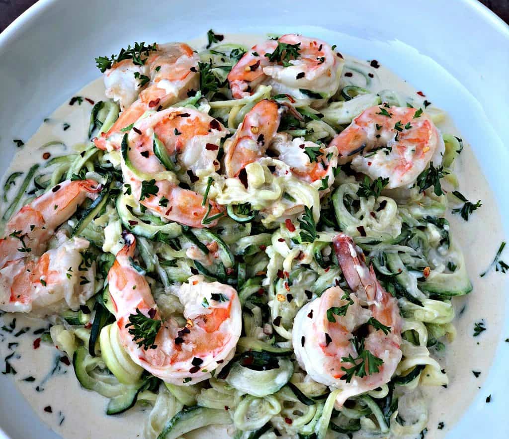 low carb zucchini alfredo in cream sauce on a white plate