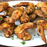 buttermilk southern fried chicken on a white serving platter