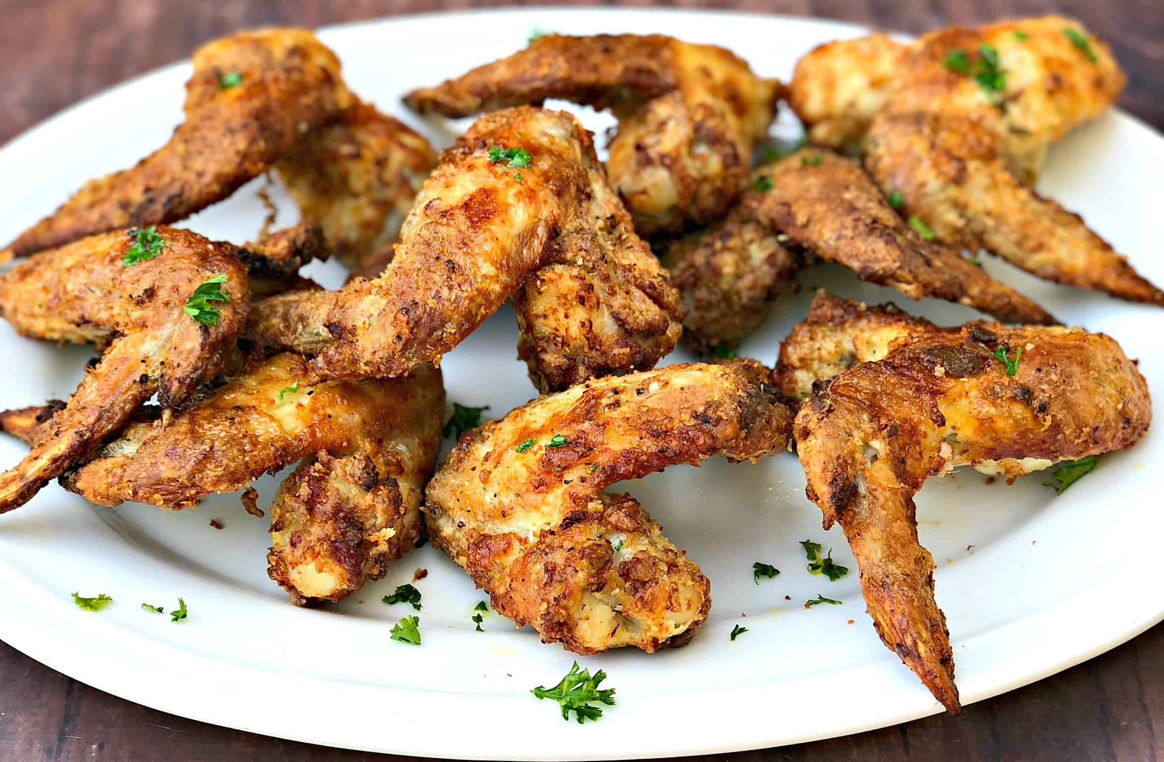 buttermilk southern fried chicken on a white serving platter