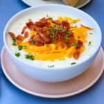 instant pot potato soup with bacon and cheese in a white bowl