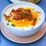 instant pot potato soup with bacon and cheese in a white bowl