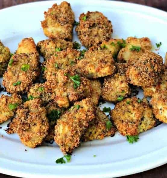 keto chicken nuggets 2 keto bacon chicken nuggets on a white plate with avocado ranch