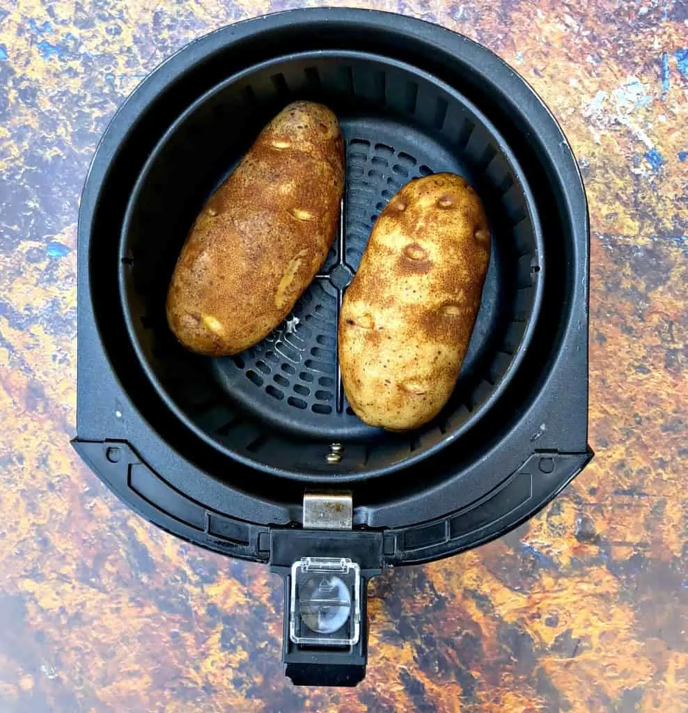 Easy, Air Fryer Loaded Stuffed Baked Potatoes is a quick recipe that will show you the time and how long to cook potatoes in the air fryer. These potatoes are stuffed with melted butter, sour cream, crunchy bacon, green onions, and chives. You can even prepare them as twice baked potatoes! potatoes in an air fryer basket