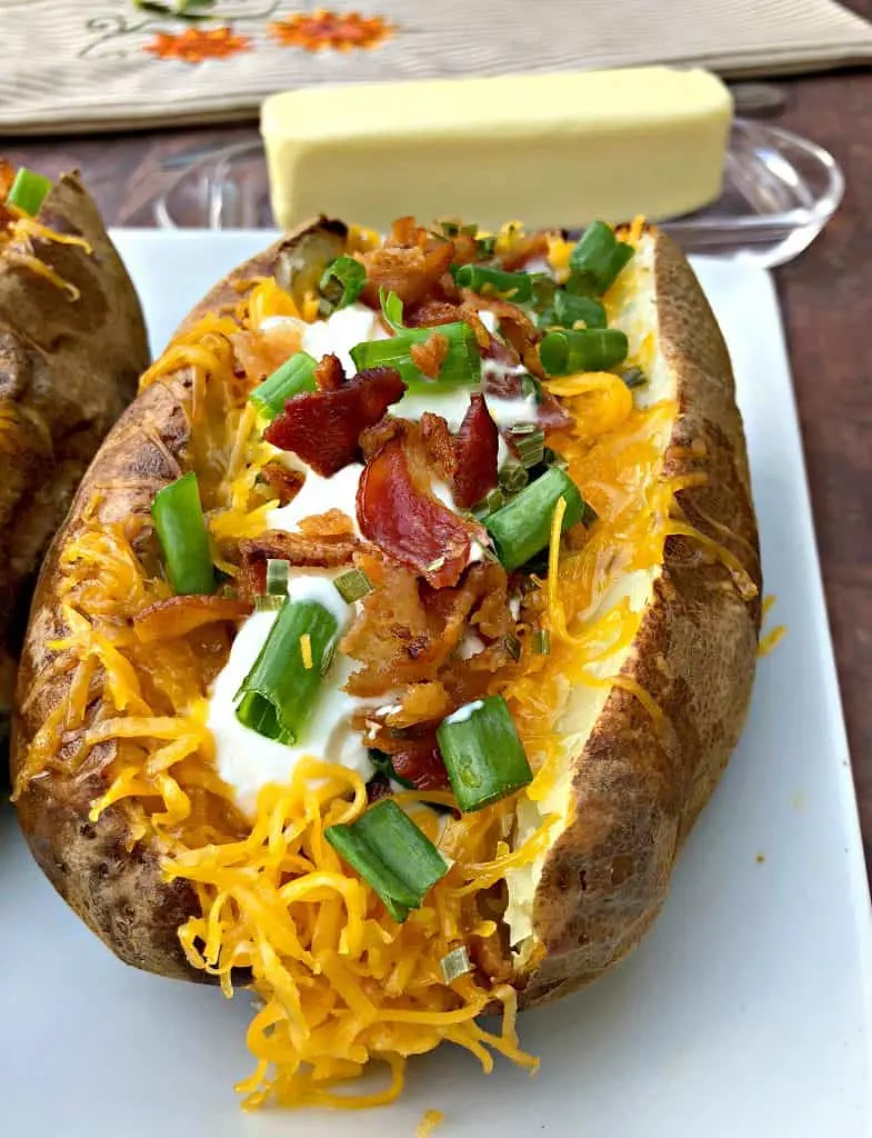 air fryer loaded baked potato on a plate with butter