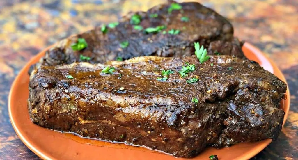 air fryer marinated steak on an orange plate