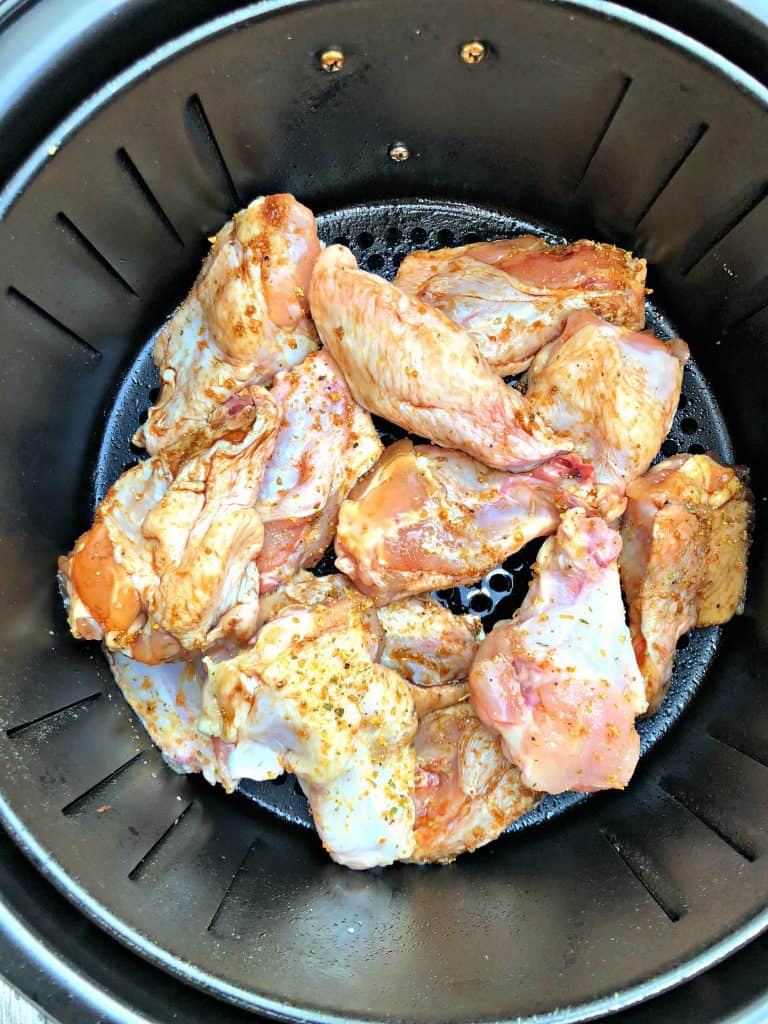 raw seasoned chicken wings in an air fryer