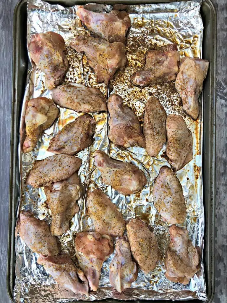 raw chicken wings on a sheet pan