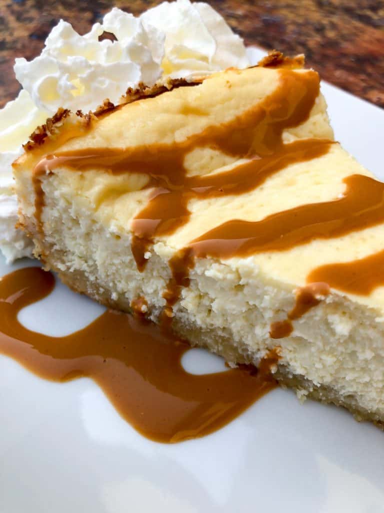 keto cheesecake low carb on a white plate with caramel and whipped cream