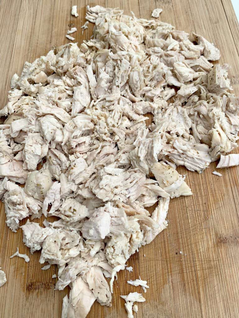 shredded chicken breast on a cutting board