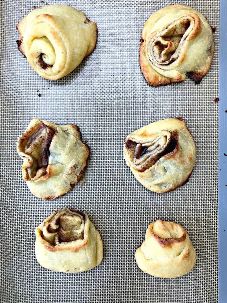 keto fathead cinnamon rolls on a cookie sheet