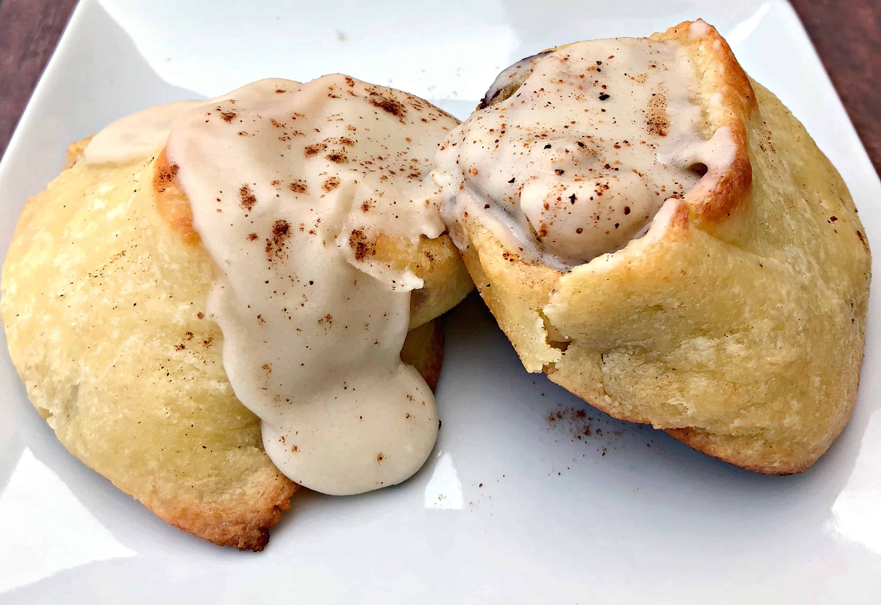 close up of keto fathead cinnamon rolls on a white plate