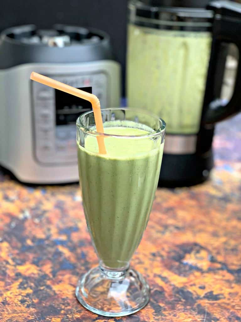 instant pot blender smoothie in a glass with a straw