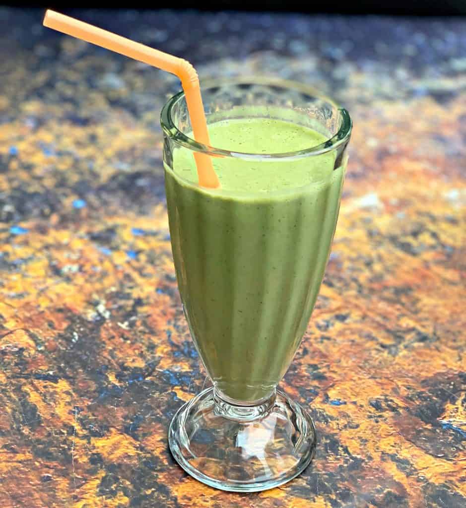 instant pot blender smoothie in a glass with a straw