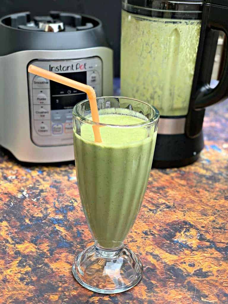 instant pot blender smoothie in a glass with a straw