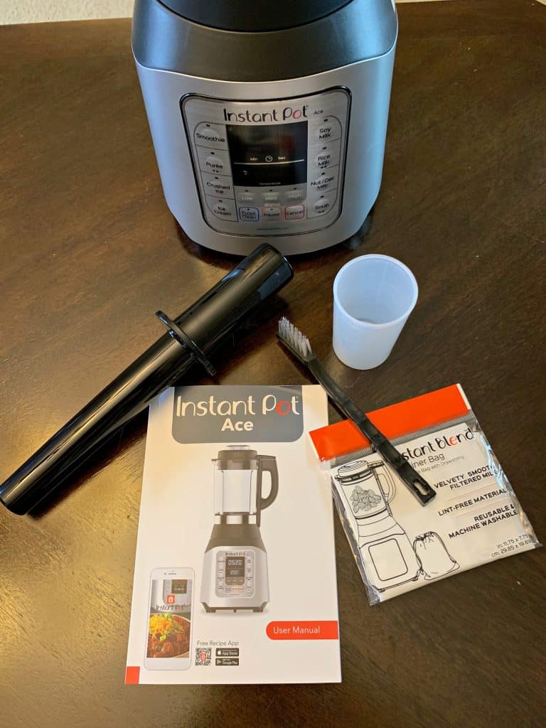 instant pot ace 60 cooking blender on a table with all boxed items