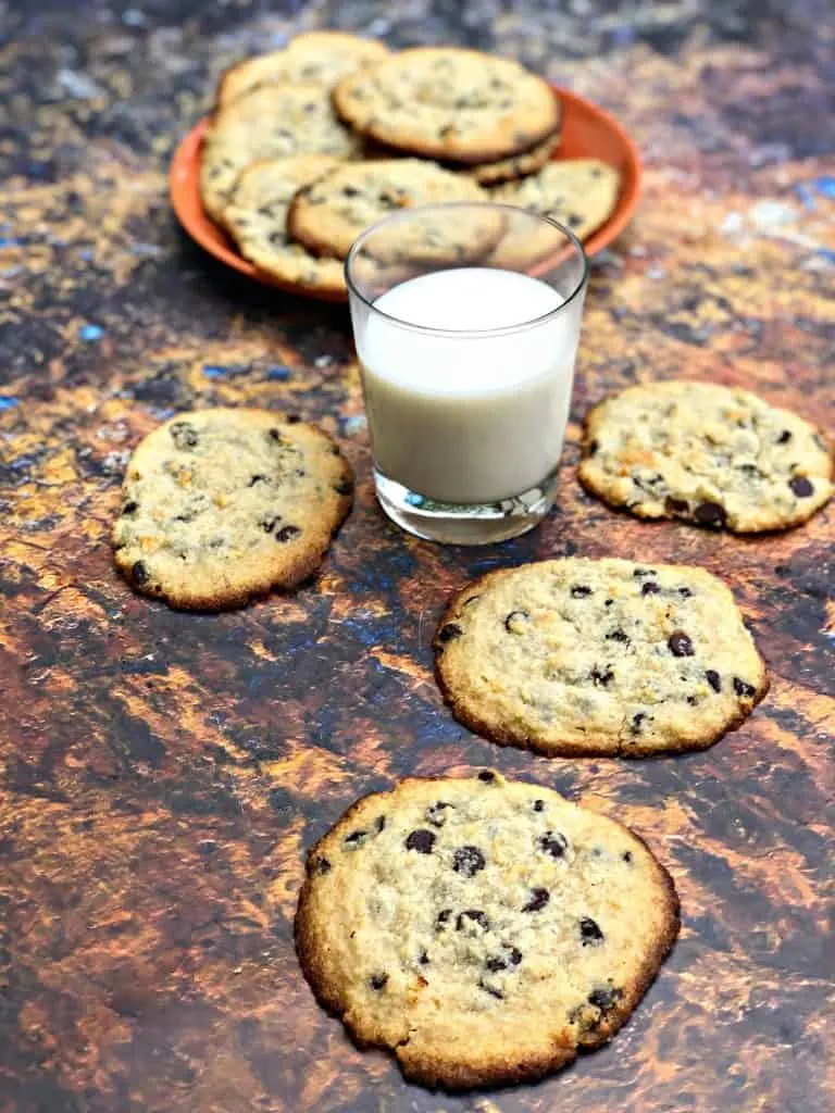 keto chocolate chip cookies on a plate with a glass of milk
