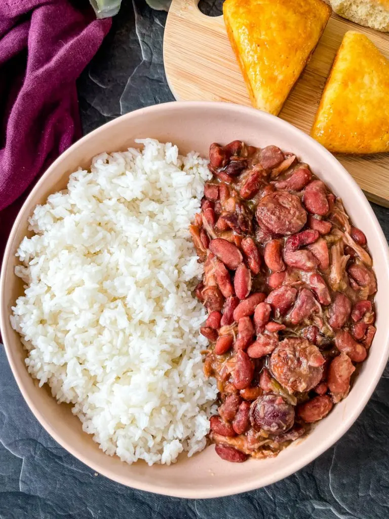 instant pot red beans and rice in a brown bowl with bread