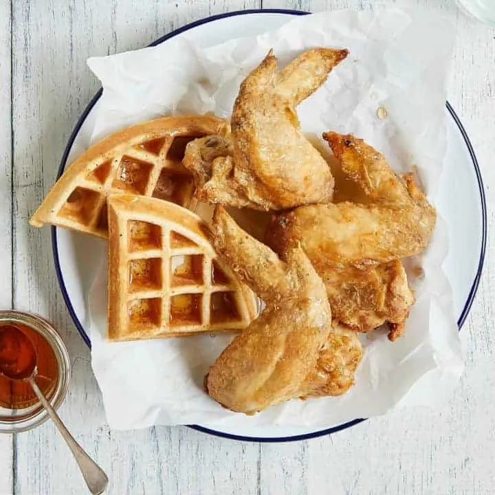 air fryer chicken and waffles on a white plate with syrup