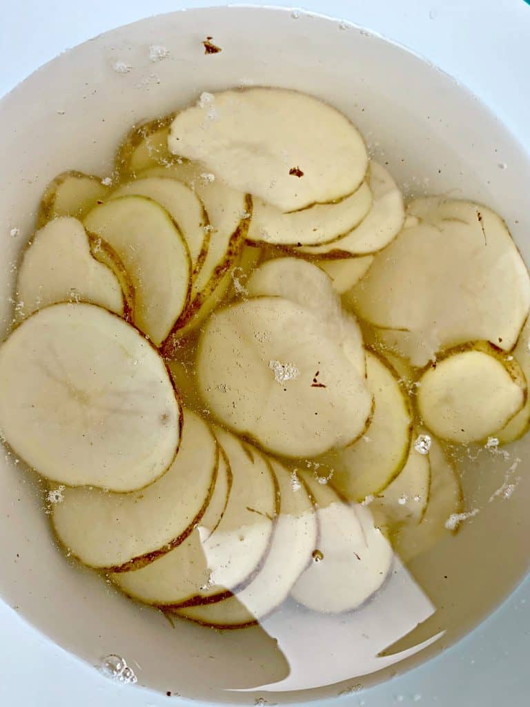 sliced potatoes in water